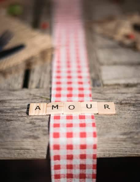 Mot AMOUR sur un chemin de table vichy des 60 lettres alphabet façon scrabble pour décoration de table en bois