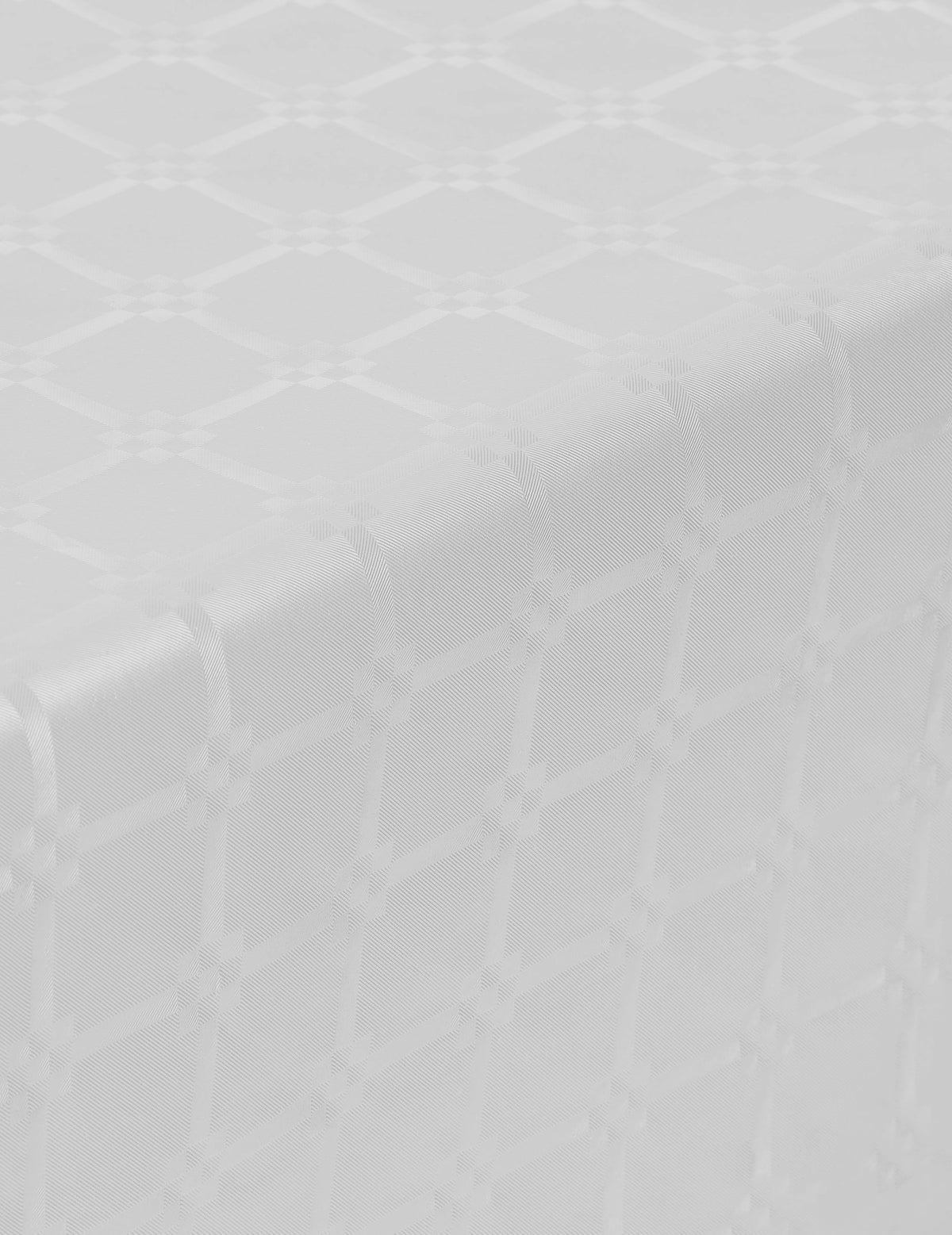 Détail du motif damassé de la nappe en rouleau papier damassé blanche
