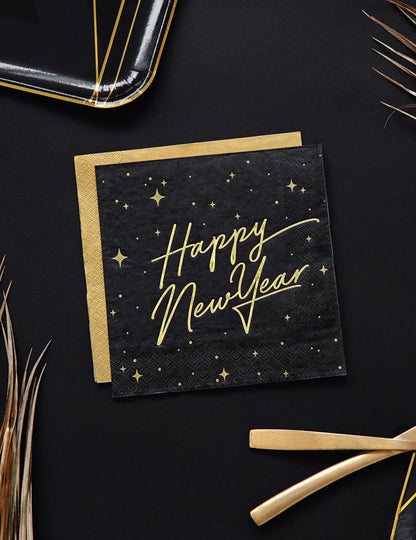 Vue de dessus des serviettes en papier Happy New Year noires et dorées avec décor étoilé