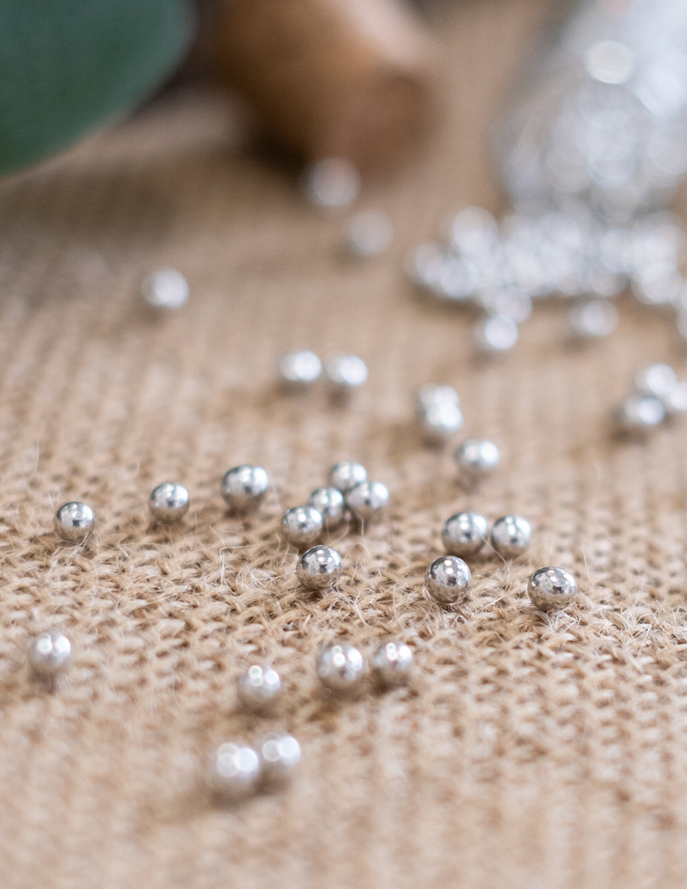 Détail des billes argentées sur toile de jute des dragées perles de mariage pour fête